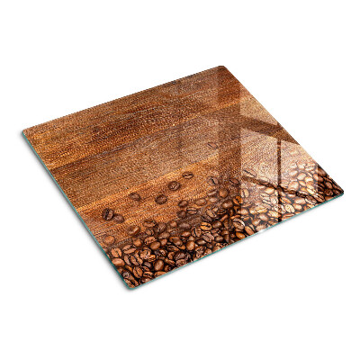 Glass chopping board Coffee beans on wooden background