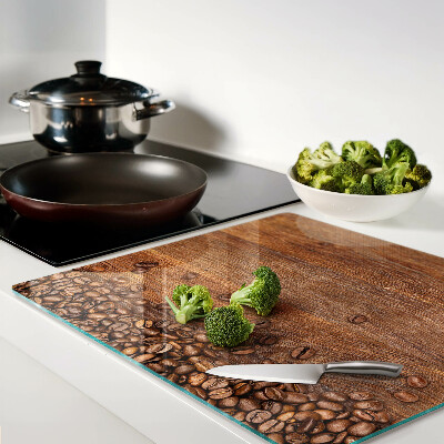 Glass chopping board Coffee beans on wooden background