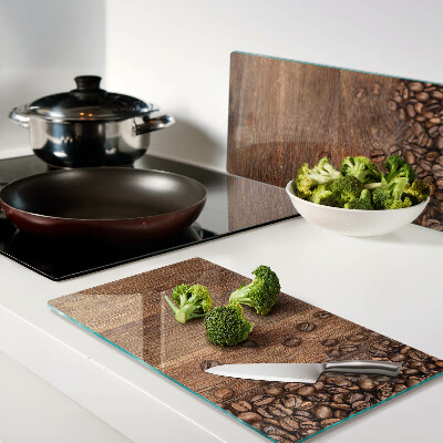 Glass chopping board Coffee beans on wooden background