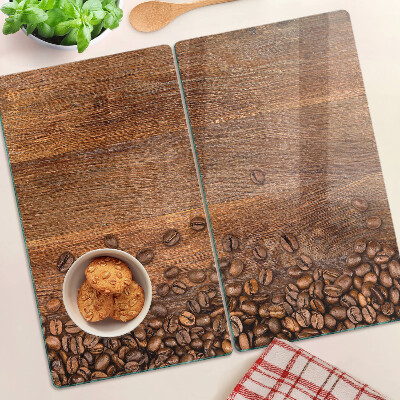 Glass chopping board Coffee beans on wooden background