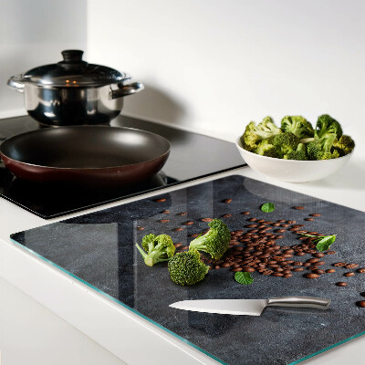 Glass chopping board Coffee beans on a stone background