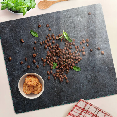 Glass chopping board Coffee beans on a stone background