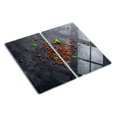 Glass chopping board Coffee beans on a stone background