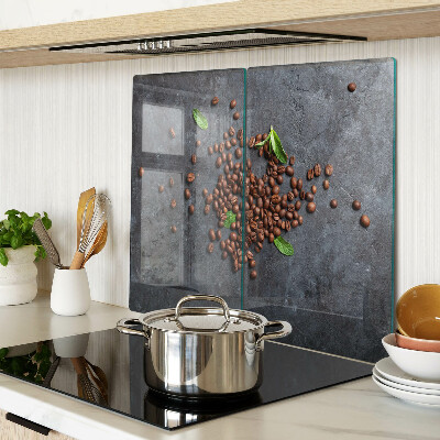 Glass chopping board Coffee beans on a stone background