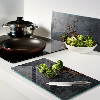 Glass chopping board Coffee beans on a stone background