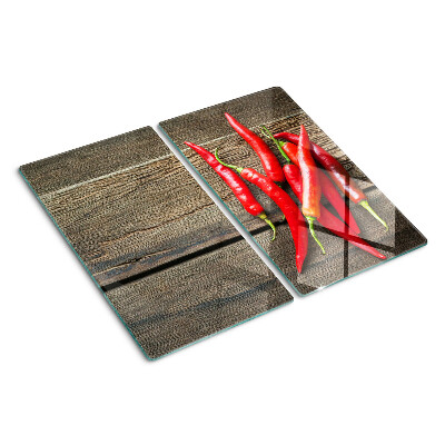 Glass chopping board Chili peppers on a wooden background