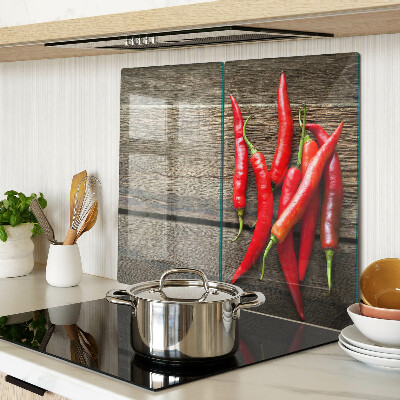 Glass chopping board Chili peppers on a wooden background