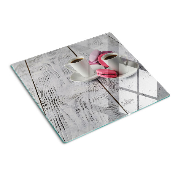 Glass chopping board Coffee and macaroons on a wooden background