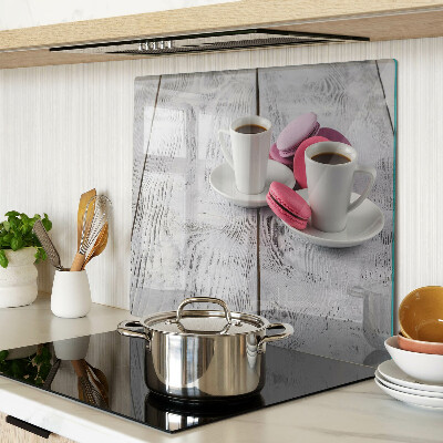 Glass chopping board Coffee and macaroons on a wooden background