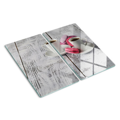Glass chopping board Coffee and macaroons on a wooden background