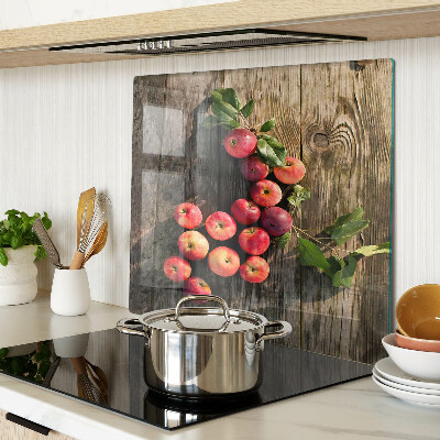Glass chopping board Apples on a wooden background