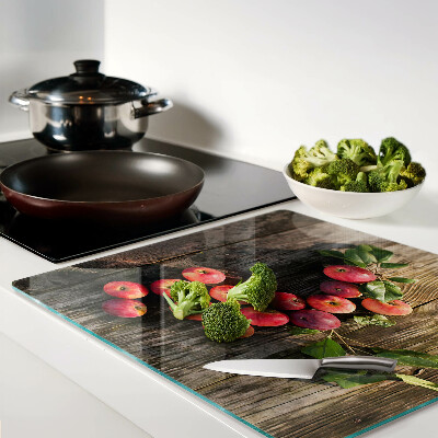Glass chopping board Apples on a wooden background