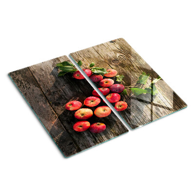 Glass chopping board Apples on a wooden background