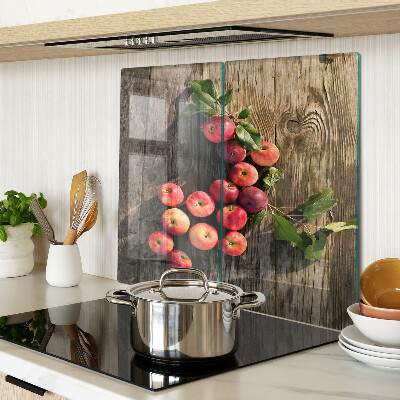 Glass chopping board Apples on a wooden background