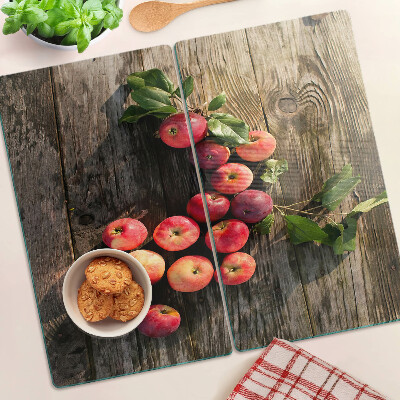 Glass chopping board Apples on a wooden background