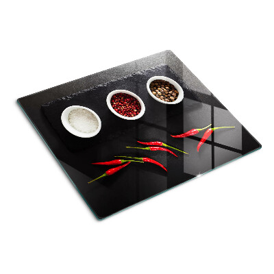 Glass chopping board Spices and red peppers