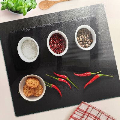 Glass chopping board Spices and red peppers