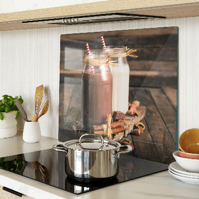 Glass kitchen board Jars with drinks on a wooden background