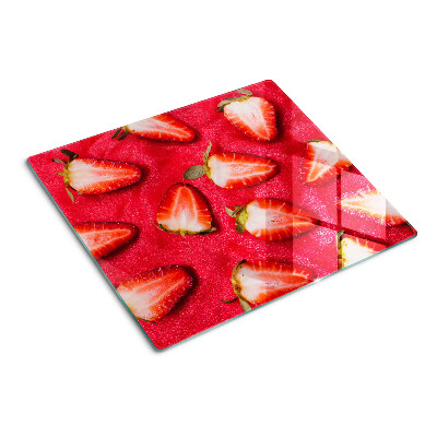 Glass chopping board Strawberries on a pink background