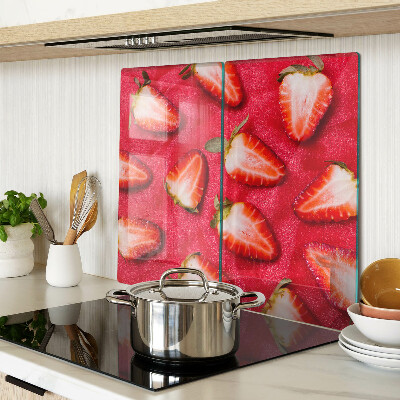 Glass chopping board Strawberries on a pink background