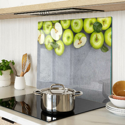 Glass chopping board Green apples on a gray surface