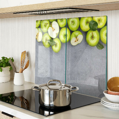 Glass chopping board Green apples on a gray surface
