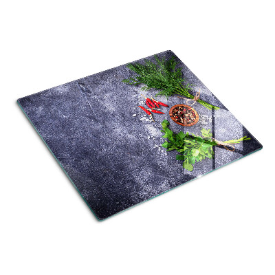 Glass kitchen board Herbs and spices on a stone background