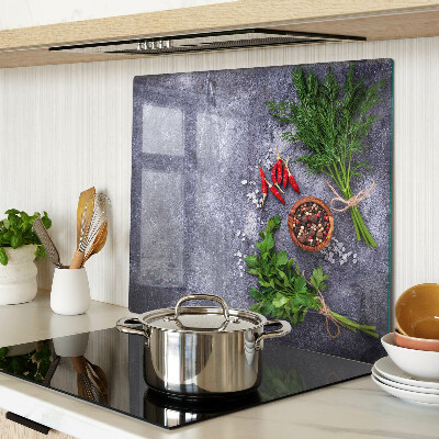 Glass kitchen board Herbs and spices on a stone background