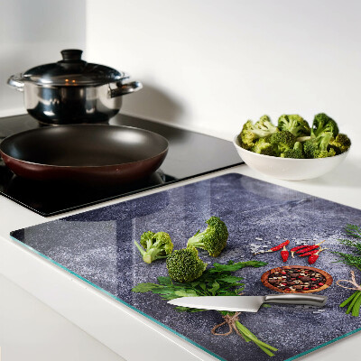 Glass kitchen board Herbs and spices on a stone background