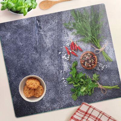 Glass kitchen board Herbs and spices on a stone background