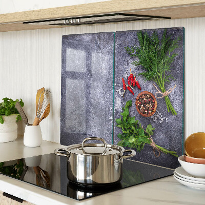 Glass kitchen board Herbs and spices on a stone background