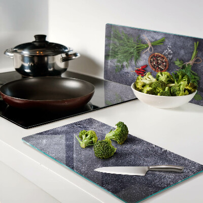 Glass kitchen board Herbs and spices on a stone background