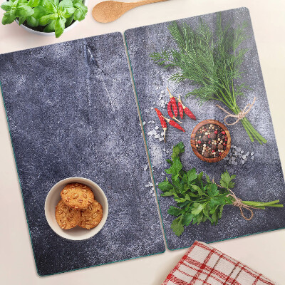 Glass kitchen board Herbs and spices on a stone background