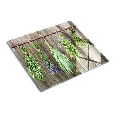 Glass kitchen board Herbs on a wooden background