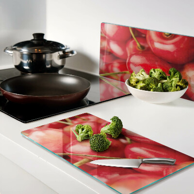 Glass kitchen board Cherries on a red background