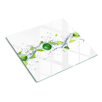 Glass kitchen board Lemons and water with leaves