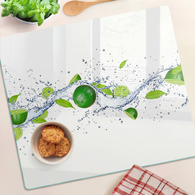 Glass kitchen board Lemons and water with leaves