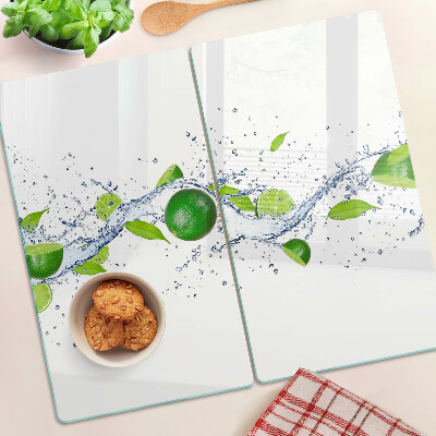 Glass kitchen board Lemons and water with leaves