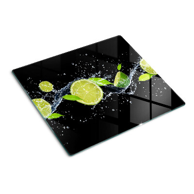 Glass chopping board Lemons in water with mint leaves