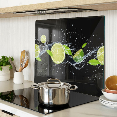Glass chopping board Lemons in water with mint leaves