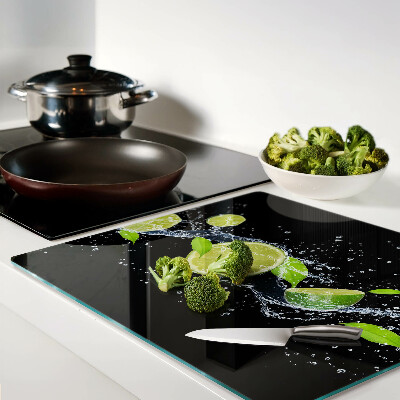 Glass chopping board Lemons in water with mint leaves