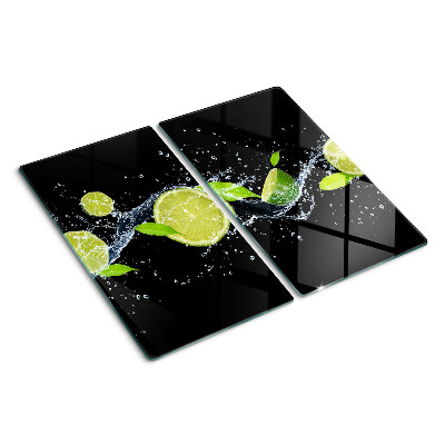 Glass chopping board Lemons in water with mint leaves