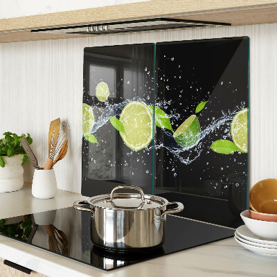 Glass chopping board Lemons in water with mint leaves