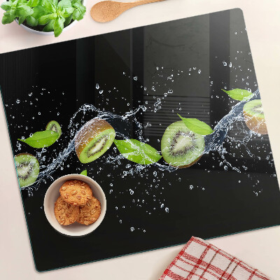 Glass chopping board Kiwi in water with leaves