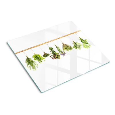 Glass chopping board Herbs dried on a string