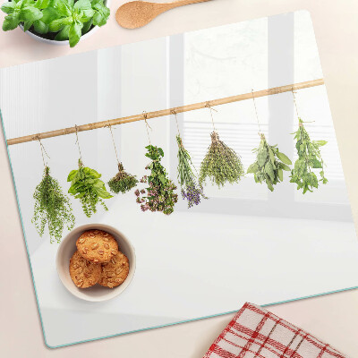 Glass chopping board Herbs dried on a string