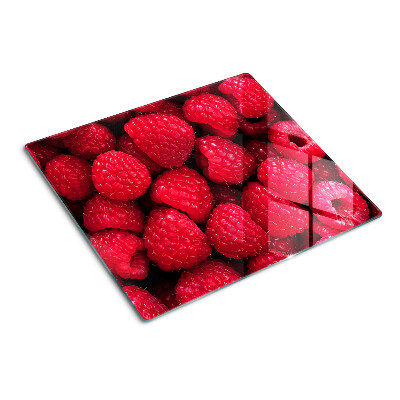 Glass chopping board Raspberries on the background