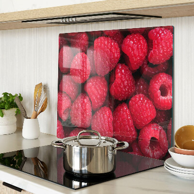 Glass chopping board Raspberries on the background