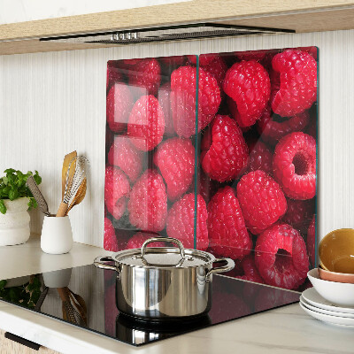 Glass chopping board Raspberries on the background