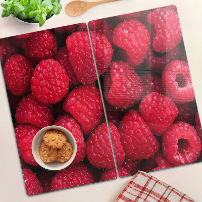 Glass chopping board Raspberries on the background